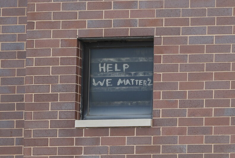 "Help we matter" written on a window
