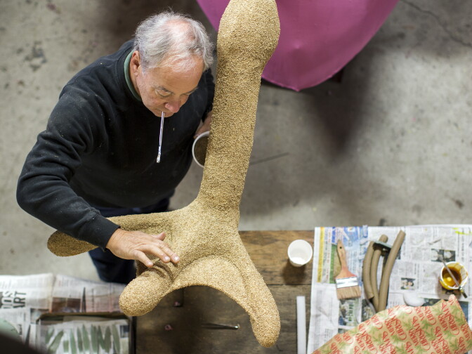 Volunteer Ken Tyminski of North Carolina patches up the foot of a flamingo at Sierra Madre Rose Float Association's barn on Tuesday morning, Dec. 29, 2015. The float will be part of the 2016 Rose Parade on New Year's Day.