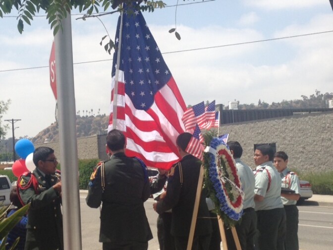 Franklin High School R.O.T.C members replace the worn American flag with a new one at the Cypress Park Veterans Memorial during the ceremony. 