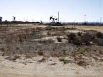 This Aug. 18, 2016 photo shows what remains of an oil-extraction operation in Banning Ranch, on what is believed to be the biggest piece of privately-owned vacant land on Southern California's coast in Newport Beach. Developers want to build 895 homes and a 75-room resort hotel on the 401-acre swath of land in upscale Newport Beach. Proponents say they would rehabilitate and preserve much of the scenic site, but opponents say the land should be left as open space. Native American groups have also begun to look into whether the site might be sacred ground.