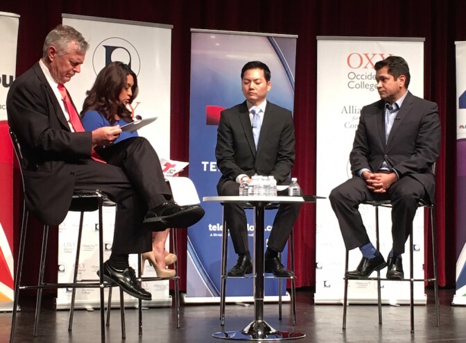 NBC4 commentator Conan Nolan, left, and Telemundo anchor Dunia Elvir moderate a forum featuring the two candidates running in the 34th Congressional District, Robert Ahn, second from right, and Jimmy Gomez, right.