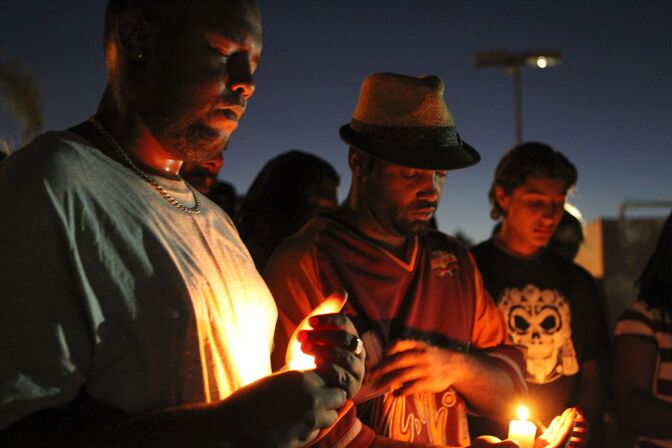 TOPSHOT - Mourners and activists hold a candle light vigil during a rally in El Cajon, a suburb of San Diego, California on September 28, 2016, in protest of the police shooting the night before.
Protesters marched in a California town following the fatal police shooting of an unarmed black man said to be mentally ill, as local officials urged calm and pledged a full investigation. The victim, identified as Ugandan refugee Alfred Olango, 30, was shot on Tuesday in the San Diego suburb of El Cajon after police received an emergency call about a man behaving erratically and walking in traffic. / AFP / Bill Wechter        (Photo credit should read BILL WECHTER/AFP/Getty Images)