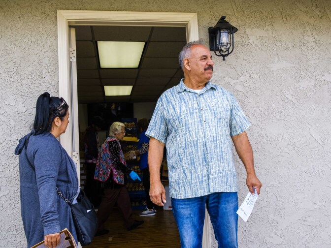 Oscar Hernandez works as a greeter, and keeps the lines moving at the Food Bank.
