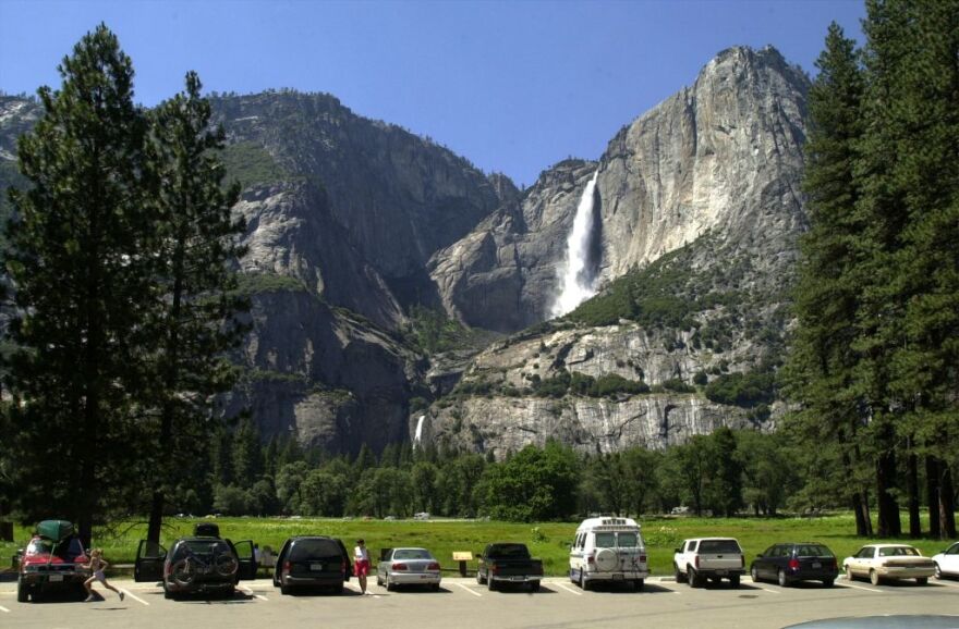 Cars fill a parking lot near Yosemite Falls (background), June 18, 2000 in Yosemite National Park, California. The National Park Service hopes to increase mass transit and reduce the number of cars within Yosemite Valley. 