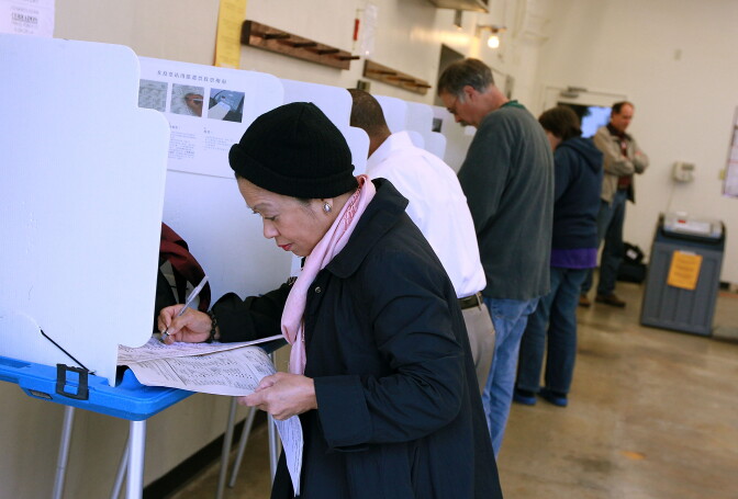 A voter fills out her ballot at a polling place at a fire station June 8, 2010 in Oakland, California. California voters are heading to the polls to vote in the primary elections for governor, U.S. senate and other statewide and local races. 