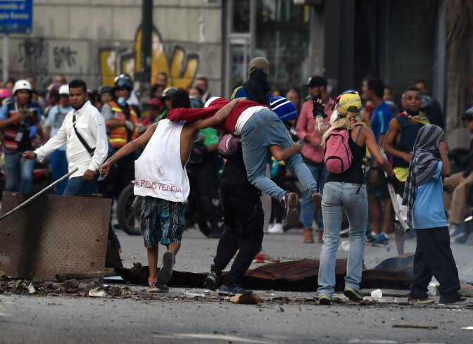 Venezuelan opposition demonstrators block the avenue during a protest against President Nicolas Maduro, in Caracas, on July 6, 2017.
A political and economic crisis in the oil-producing country has spawned often violent demonstrations by protesters demanding Maduro's resignation and new elections. The unrest has left 91 people dead since April 1. / AFP PHOTO / JUAN BARRETO        (Photo credit should read JUAN BARRETO/AFP/Getty Images)