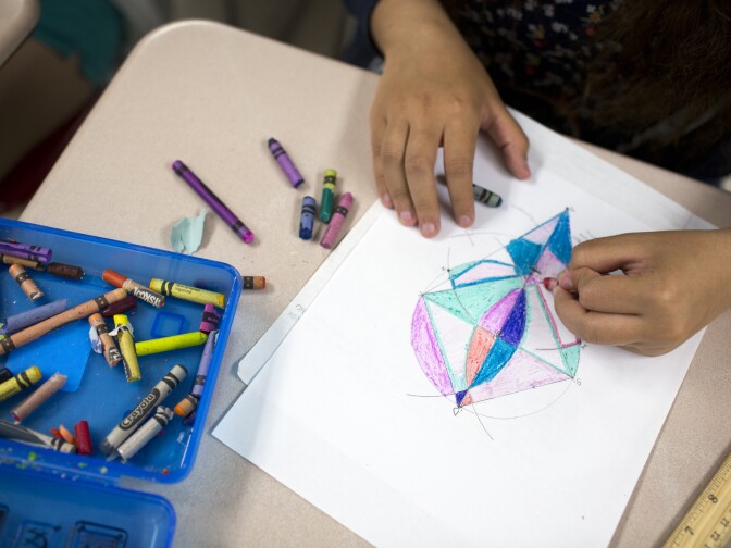 Geometry students at Hawthorne High School color in their artworks inspired by Wassily Kandinsky's "Circles in a Circle" painting. Teacher Ding-ay Tadena asks students to title their work when they're finished.