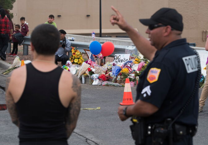 Police and state troopers keep watch outside the Cielo Vista Mall Wal-Mart (background) where a shooting left 20 people dead in El Paso, Texas, on August 4, 2019. - The United States mourned Sunday for victims of two mass shootings that killed 29 people in less than 24 hours as debate raged over whether President Donald Trump's rhetoric was partly to blame for surging gun violence. The rampages turned innocent snippets of everyday life into nightmares of bloodshed: 20 people were shot dead while shopping at a crowded Walmart in El Paso, Texas on Saturday morning, and nine more outside a bar in a popular nightlife district in Dayton, Ohio just 13 hours later. (Photo by Mark RALSTON / AFP)        (Photo credit should read MARK RALSTON/AFP/Getty Images)