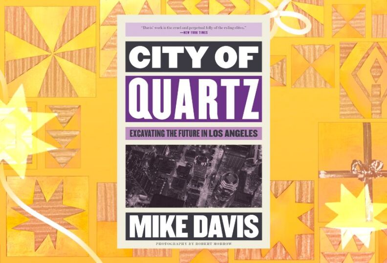 A photograph of a book cover entitled, "City of Quartz: Excavating The Future In Los Angeles," by Mike Davis. The cover includes an overhead view of downtown Los Angeles, and the design includes shades of purple. The image is set against a festive gold background accented with images of stars, gift boxes and ribbons.