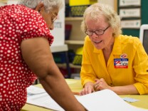 Poll clerk Barbara Rotelli helps looks up voter information at Canyon Springs School's library on Tuesday evening, June 3 in Santa Clarita during Los Angeles County's primary election.