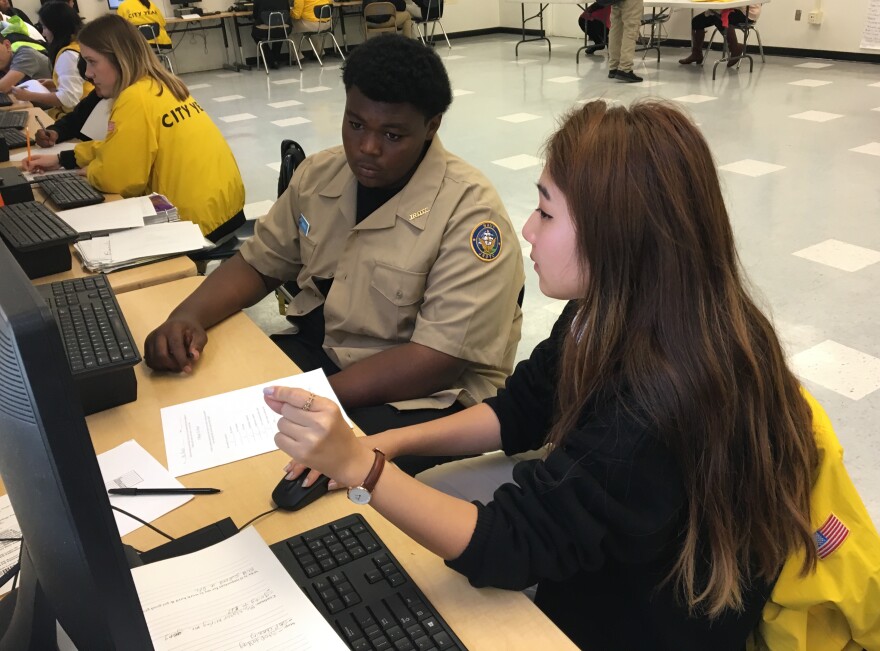 Floyd Maxey (left), a freshman at Alain Leroy Locke College Preparatory Academy, a charter high school in South L.A., goes over his grades with City Year corps member Eleanor Kim.