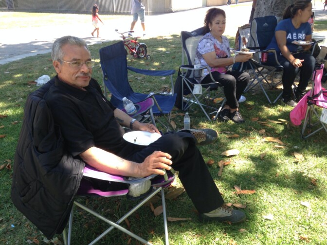 Tony Reynoso relaxes with relatives at South Gate Park on July 4, 2016. Reynoso came to the U.S. from Mexico in 1973. He said he felt thankful for an adopted country that has received him "with open arms."