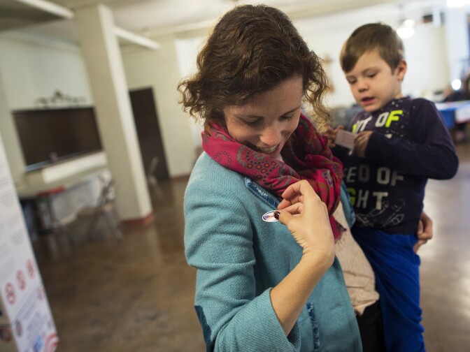 Allison Bajracharya and her  3-year-old son, Leo, put on "I Voted" stickers after voting during the Los Angeles County primary election on Tuesday, March 3, 2015 at Saint Mary of the Angels in Los Feliz.