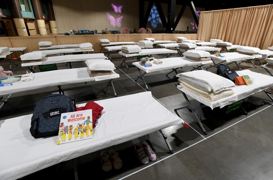 Cots for migrant children are shown set up side-by-side inside Exhibit Hall B of the Long Beach Convention Center during a tour on April 22, 2021.