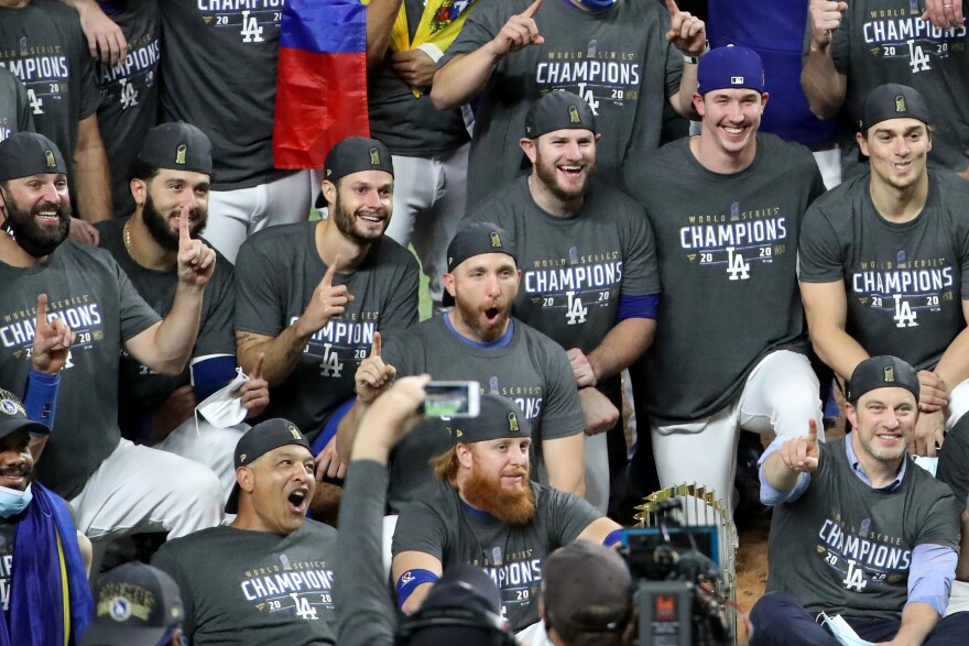 ARLINGTON, TEXAS - OCTOBER 27:  Justin Turner #10 of the Los Angeles Dodgers poses for a photo with his teammates after the teams 3-1 victory against the Tampa Bay Rays in Game Six to win the 2020 MLB World Series at Globe Life Field on October 27, 2020 in Arlington, Texas. (Photo by Sean M. Haffey/Getty Images)