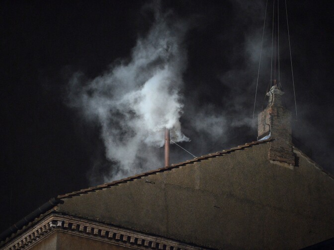 White smoke rises from the chimney on the roof of the Sistine Chapel meaning that cardinals elected a new pope on the second day of their secret conclave on March 13, 2013 at the Vatican.