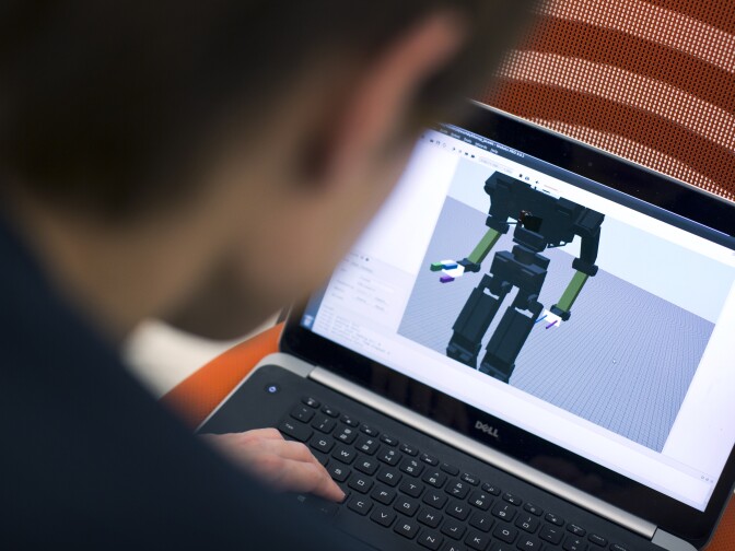 Min Sung Ahn works with THOR through a laptop on Friday, May 8, 2015 inside UCLA's Robotics and Mechanisms Laboratory. Though the team has been working on the robot for years, it struggles with daily tasks like getting in and out of cars.