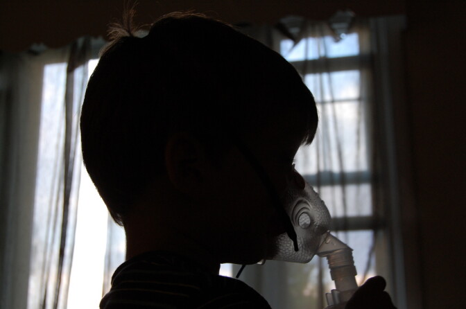 A child with severe asthma uses a respirator to breathe.