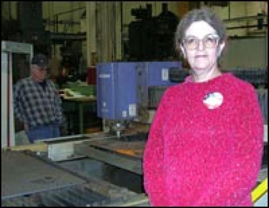 Flo Moore oversees the weld and fabrication unit of armor production at the Rock Island Arsenal. She hopes her work helps protect her son and his comrades in an Illinois National Guard unit. They recently left for Iraq.