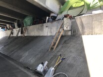 Tents line an underpass along the Santa Ana River near Angel Stadium. 