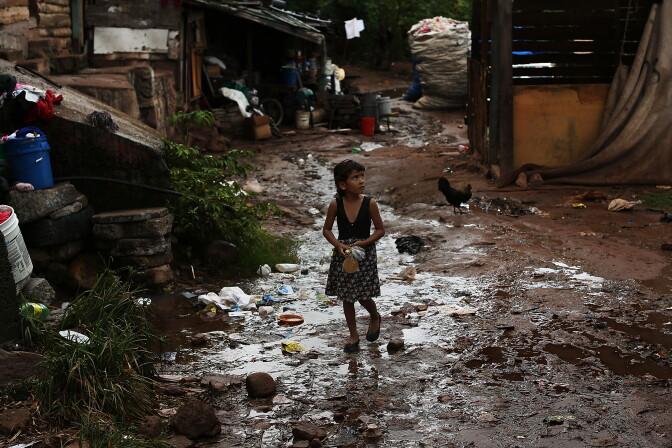 A young child walks home in an area known for heavy drug dealing on July 18, 2012 in Tegucigalpa, Honduras. Honduras now has the highest per capita murder rate in the world and its capital city, Tegucigalpa, is plagued by violence, poverty, homelessness and sexual assaults. With an estimated 80% of the cocaine entering the United States now being trans-shipped through Honduras, the violence on the streets is a spillover from the ramped rise in narco-trafficking. The non-governmental organization Doctors Without Borders has set up a program in the capital that looks to provide medical and psychological care to the homeless population. Each day a team goes out into the streets to meet with vulnerable groups of homeless to assess their needs.   