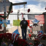 David Santos visits a make shift memorial for those killed and injured setup near the Inland Regional Center on December 7, 2015 in San Bernardino, California. 14 people died and another 17 were injured on December 2, 2015 in a mass shooting.