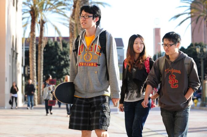 USC students on their way to attend a memorial service on April 18, 2012 in Los Angeles, California, for the two Chinese graduate students who were shot to death near campus last week. US authorities have offered $200,000 in reward money to find whoever killed the two students, after more funds were pledged on April 17.  Los Angeles has a large Chinese and Chinese-American population, including many overseas students and certain areas of the city are known for frequent gun violence. AFP PHOTO/Frederic J. BROWN (Photo credit should read FREDERIC J. BROWN/AFP/Getty Images)