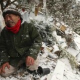 A sixty-six-year-old man Yoshikatsu Hiratsuka cries in front of his collapsed house with his mother still missing, possibly buried in the rubble, at Onagawa town in Miyagi prefecture on March 17, 2011.