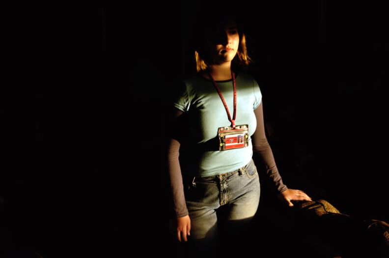 Dawn and Mike Cantrall's daughter, a seventh-grader at Brittan Elementary School, poses at her Sutter, Calif., home, wearing the Radio Frequency Identification tag that the school asked her to wear on Tuesday, Feb. 8, 2005. The Cantralls have filed a formal complaint against the school board, protesting the tag. The elementary school in this tiny rural school district has become an unlikely pioneer on the technology frontier by agreeing to test student I.D. cards designed to automatically take attendance. The badges use the same Radio Frequency Identification (RFID) technology that has been used to track livestock and store inventory and have outraged some parents with privacy concerns who say they were never consulted.
