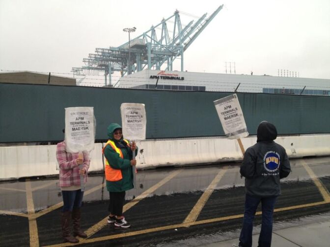 Striking clerical workers at Pier 400 walk the picket lines Thursday at the Port of Los Angeles.