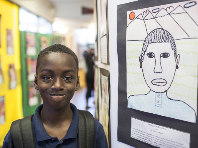 Fourth grader Dalevon Moore’s self-portrait was inspired by Frida Kahlo. His piece, titled “Hiking on the Mountains," uses pencils, markers and crayons. Moore’s self-portrait is on display during an art show at Florence Griffith Joyner Elementary School in Watts on Tuesday afternoon, Oct. 11, 2016.