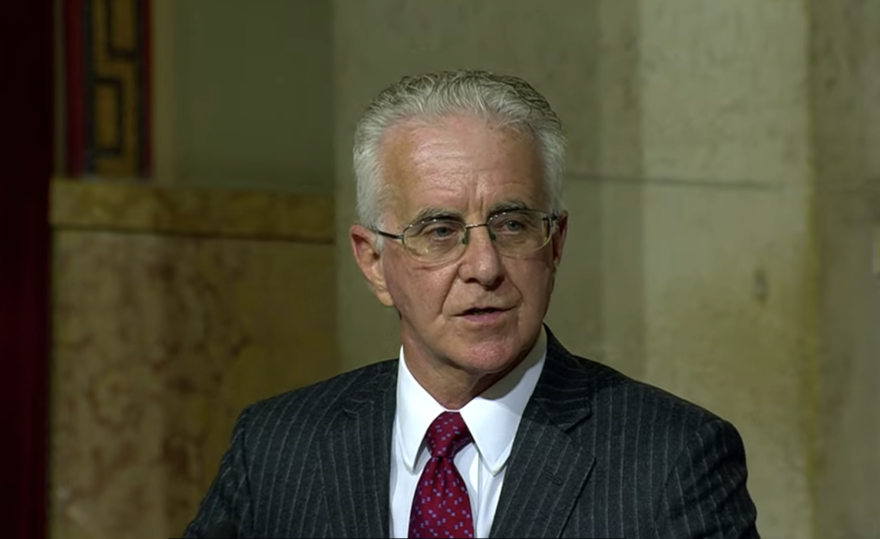 An image of LA City Councilmember Paul Krekorian. He wears eyeglasses and his mostly silver hair is combed back. He is wearing a dark, pin-striped suit jacket with a white shirt and red tie.