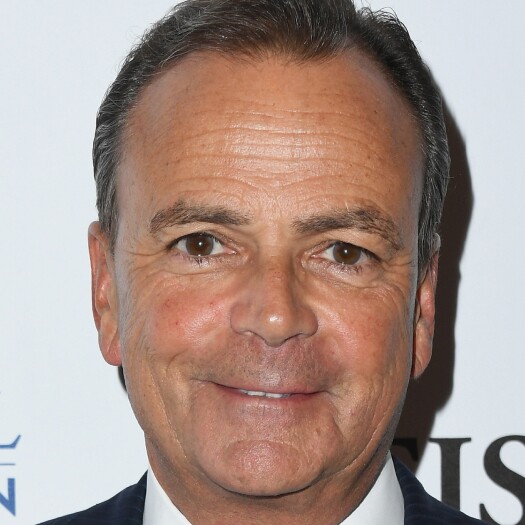 Headshot of Rick Caruso. He's smiling and wearing a white shirt and dark jacket. He has short dark gray hair and a light complexion.