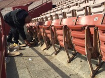 Francis Gonzalez cleans up trash at the LA Memorial Coliseum, which has reached a milestone: zero waste after football games. Gonzalez is a project supervisor with ABM.
