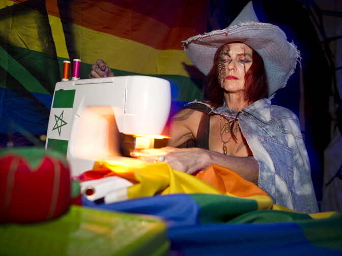 A witch sews rainbow flags with the Star of David inside a room at KillJoy's Kastle: A Lesbian Feminist Haunted House. Artists Deirdre Logue and Allyson Mitchell want the haunted house to "pervert, not convert."