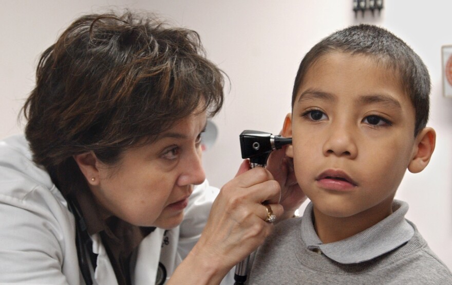 Dr. Chris Taylor, left, examines the ear of Medi-Cal patient Richardo Alvarez, 5, at the Las Palmas Health Clinic in Sacramento, Calif., in 2005. Across the nation, Medicaid costs are rising rapdily and squeezing governments, poor people, doctors, hospitals and other health care providers. In California, which has one of the nation's lowest reimbursment rates, many doctors and dentists don't take Medi-Cal patients.