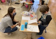 Transitional kindergarten teacher Heidi Ardin speaks with one of her students at Harding Elementary in Sylmar on April 13, 2021, the first day of L.A. Unified School District's transition to "hybrid" instruction since the beginning of the COVID-19 pandemic.