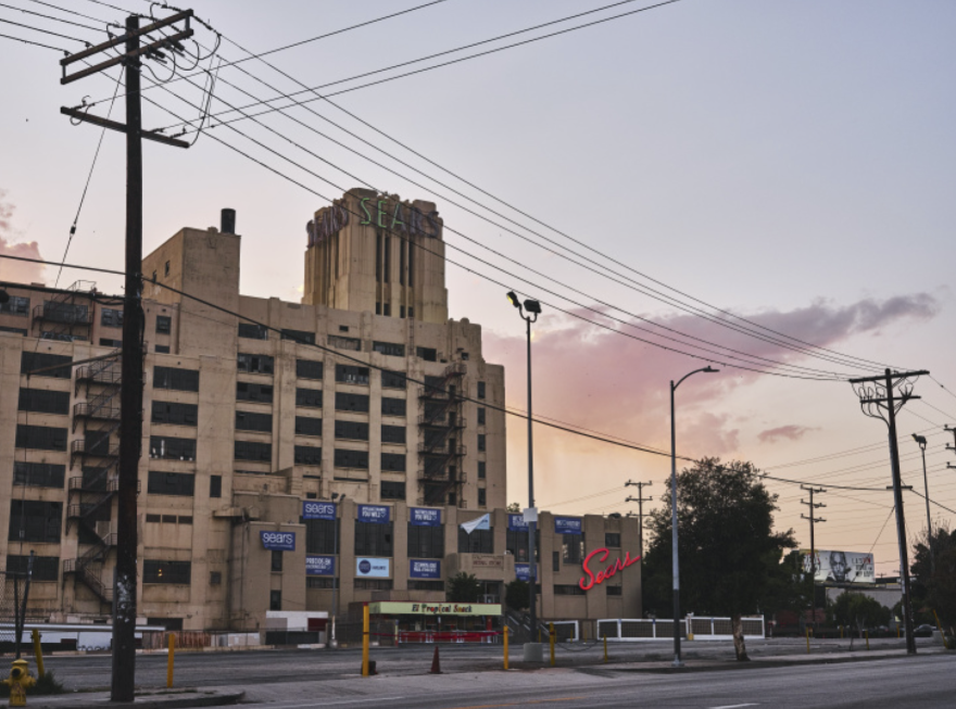 The Boyle Heights Sears store is framed against a sunset.