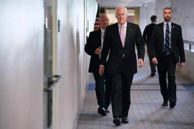 WASHINGTON, DC - OCTOBER 26:  Senate Intelligence Committee member Sen. John Cornyn (R-TX) is accompanied by plain-clothed U.S. Capitol Police as he arrives for a classified hearing at the Hart Senate Office Building on Capitol Hill October 26, 2017 in Washington, DC. The committee advanced legislation that would reauthorize Section 702 of the FISA Amendments Act, which enables the government to collect foreign intelligence on U.S. soil.  (Photo by Chip Somodevilla/Getty Images)