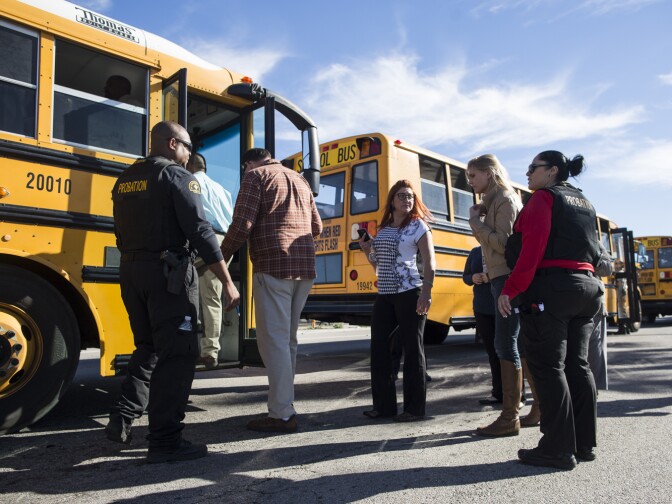 Employees are evacuated from the Inland Regional Center and led into buses following a mass shooting inside the San Bernardino building on Wednesday, Dec. 2, 2015.
