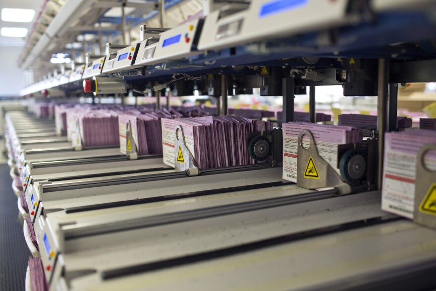 Vote-by-mail ballots are sorted into their appropriate district after arriving at the Los Angeles County Registrar/Recorder building in Norwalk on Friday, Oct. 17. The earliest-arrivng mail-in ballots are the first to be counted after the 8 p.m. poll-closing time.