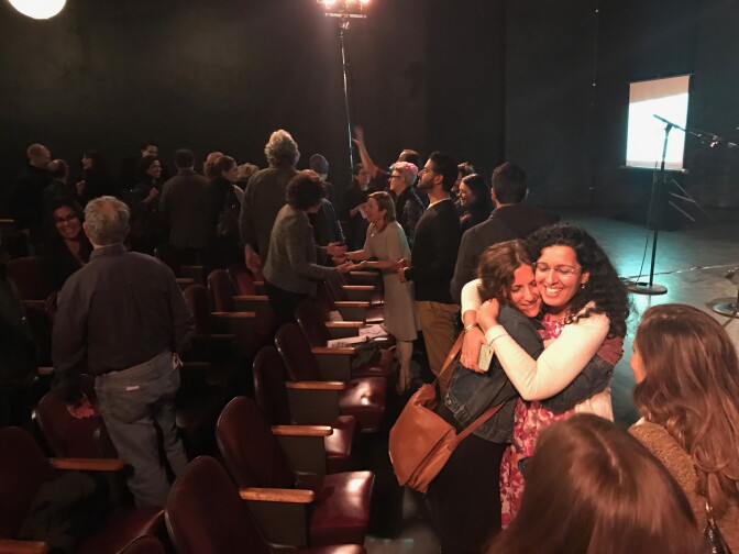 Participants hug at a recent storytelling event at The Hayworth Theatre in Los Angeles.