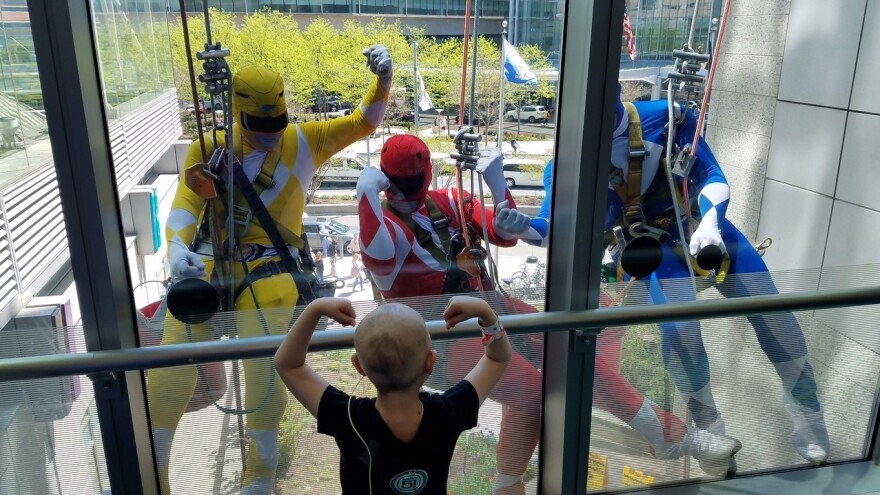 Window washers dressed as Power Rangers dangled outside Children's Hospital in Philadelphia this week. They thrilled the kids including one little girl who exchanged muscle poses with them.