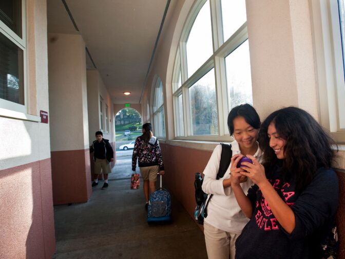 Marguerita Elementary School sixth graders Stacey Zhu, left, and Diona Deng hang out the hallway of a new two-story building on the school's campus. The building, which houses classrooms, opened in September.