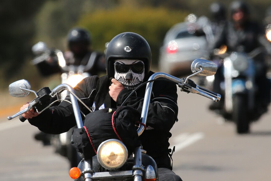 PERTH, AUSTRALIA - SEPTEMBER 12: A Rebels motorcycle club member rides from Meckering to Perth on September 12, 2013 in Perth, Australia. An estimated 1000 Rebels from chapters all over Australia gather for the road trip across the country to Perth.  (Photo by Paul Kane/Getty Images)