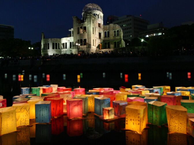 HIROSHIMA, JAPAN - AUGUST 06:  Paper lanterns float on the Motoyasu River in front of the Hiroshima Peace Memorial, commonly called the Atomic Bomb Dome, at the Hiroshima Peace Memorial Park on August 6, 2012 in Hiroshima. Japan. Japan is marking the 67th anniversary of the first atomic bomb dropped on Hiroshima by the United States on August 6, 1945, which killed an estimated 70,000 people instantly and many thousands more over the following years from radiation. Three days later another atomic bomb was dropped on Nagasaki, that effectively ended World War II.  (Photo by Buddhika Weerasinghe/Getty Images)