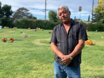 Julio Osorio stands in the Valhalla Memorial Park Cemetery near his mother's grave. (Emily Elena Dugdale/KPCC)