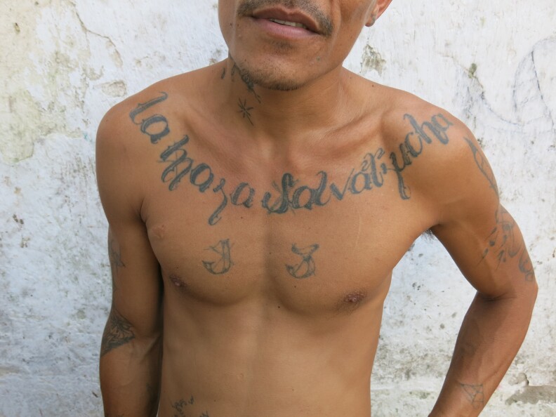 Lagrima, a founding member of the Mara Salvatrucha in Honduras, shows gang tattoos in a prison yard. (Photo used by permission of author Ioan Grillo.)