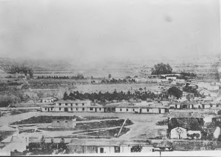 A black and white photo of low-flung buildings