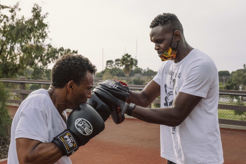 Personal trainer Alexander Ayodele (right) works out with a client